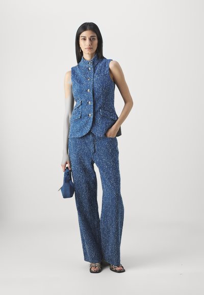 Blue textured vest with a high collar and front buttons, paired with matching wide-leg trousers. The outfit features two front pockets.