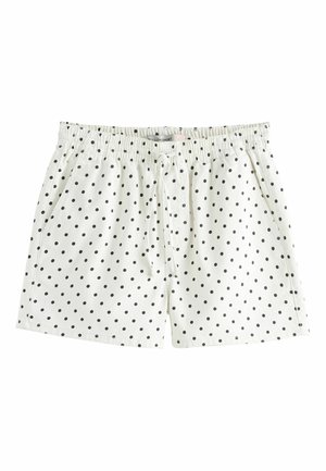 Białe szorty z elastycznym pasem, czarnymi groszkami, regulowanym wiązaniem z przodu i bocznymi kieszeniami.