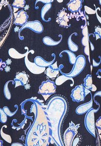 Navy fabric with blue and light pink paisley and floral patterns. Features intricate designs with curved shapes and a smooth texture.