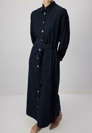 Navy long-sleeve dress with a button front, collar, and a waist tie, featuring light blue buttons and a smooth fabric texture.