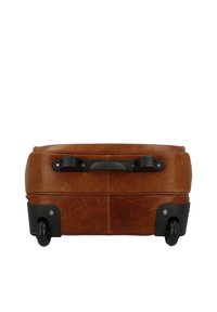 Brown leather suitcase lying flat, showing black handle and two small black wheels on a white background.