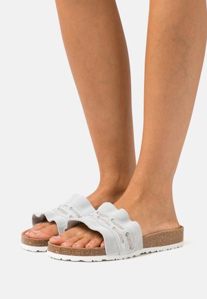 Helles, blaugraues, flauschiges Schlüpfschuhmodell mit gewelltem Design, Korksohle und weißer Gummisohle. Verfügt über dekorative Stickereien.