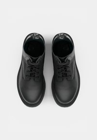 Black leather high-top shoes with round toe, lace-up front, and textured finish. Features a rubber sole and contrasting inner lining.