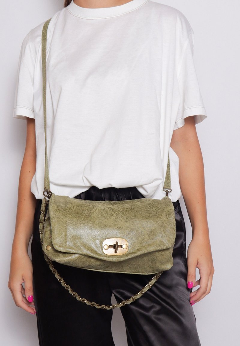 Borsa a tracolla in pelle verde oliva con patta a pieghe, chiusura metallica e dettagli della tracolla intrecciata. Texture liscia e forma rettangolare.