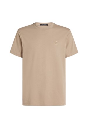 T-shirt en coton beige avec un col rond, des manches courtes et un petit logo brodé sur la poitrine. Texture lisse, coupe décontractée.