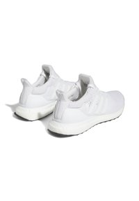 White athletic shoes featuring a knitted upper, three white side stripes, a textured heel, and a cushioned white midsole with black outsole.