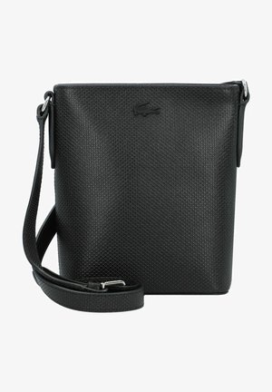 Sac bandoulière noir avec texture, fabriqué en matériau synthétique, doté d'une fermeture éclair, d'une sangle réglable et d'un logo en relief sur le devant.