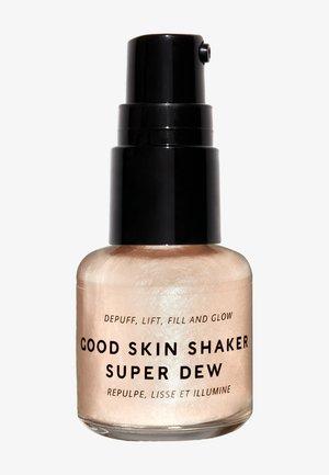 Flacon d'enlumineur liquide scintillant étiqueté "Good Skin Shaker Super Dew" avec un distributeur noir sur fond blanc.