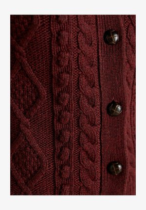 Burgundy knitted cardigan featuring textured cable patterns, smooth accents, and dark brown buttons, creating a rich, layered appearance.
