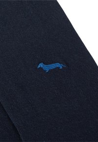 Navy socks made of soft material featuring a blue embroidered dachshund design. The texture is smooth with a subtle finish.