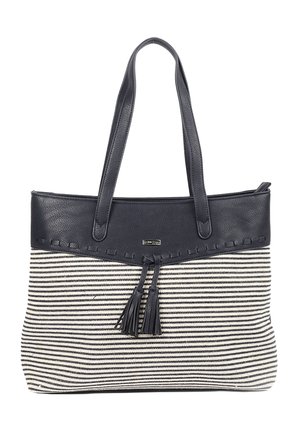 Sac cabas rayé noir et blanc avec dessus en cuir noir, doubles poignées et deux pompons en cuir suspendus au centre devant.