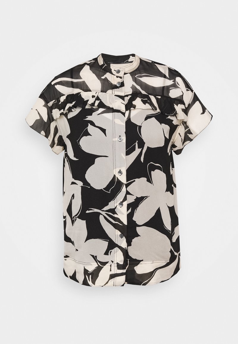 Blouse noire à manches courtes avec grands motifs floraux beiges, fermeture boutonnée à l'avant et détail volanté sur la poitrine et les épaules.