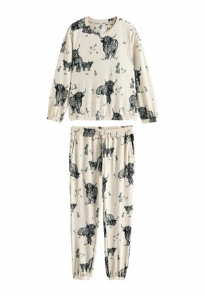Cotton loungewear set in cream with black animal print. Long-sleeve top with elastic cuffs, pants with an elastic waistband and pockets.