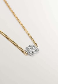 Collar de cadena de oro con un colgante de gema transparente en corte esmeralda y diamantes de acento, exhibiendo un acabado metálico pulido y eslabones intrincados.