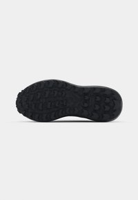 Black sneaker sole with deep tread pattern, featuring multiple traction lugs and a textured surface for grip and durability.