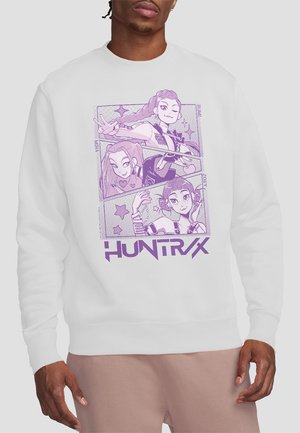 Sweatshirt with purple anime-style illustrations of three female characters posing, labeled Rumi, Myra, and Zoey, and "HUNTRX" text below.