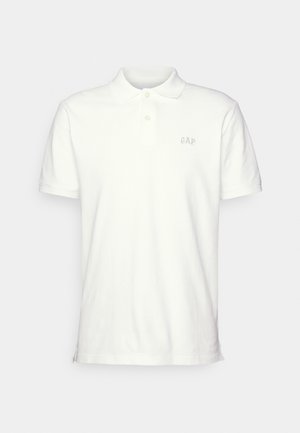 White polo shirt made from textured cotton, featuring a classic collar, two button placket, and embroidered GAP logo on the chest.