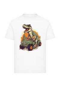 White t-shirt featuring an illustrated T-rex driving a green jeep, with an orange backdrop and detailed textures.