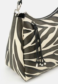 Zebra-print handbag with a smooth leather finish, featuring a black zipper, knotted black tassel detailing, and metallic accents.