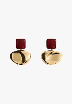 Gold-tone abstract oval earrings with dark red square studs at the top, shown against a white background.