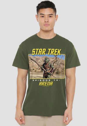 Olive green T-shirt featuring a graphic of a green alien with a stick, framed by "STAR TREK" and "EPISODE 19: ARENA" text.
