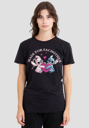 Black cotton T-shirt featuring a graphic design of two characters holding a pink heart, with text "MADE FOR EACH OTHER" above.