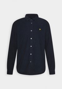 Granatowa koszula na guziki z długim rękawem wykonana ze sztruksu, z kołnierzykiem i małym żółtym logo ptaka na lewej piersi.