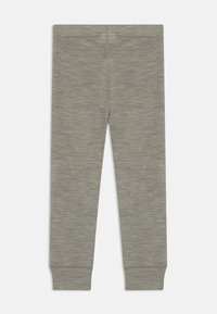 Grå leggings gjorda av ett lätt, stretchigt tyg. Har en slät textur, figurnära design och elastisk midja med smalnande mudd.