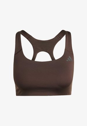 Brūns sporta krūšturis ar racerback dizainu, centrā ar izgriezumu. Izgatavots no gludas auduma ar mazu logotipu augšējā labajā pusē.