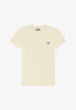 Maglietta di cotone color crema con scollo rotondo e maniche corte. Presenta una piccola grafica nera di coltelli incrociati sul lato sinistro del petto.