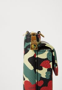 Multicolored leather bag featuring a camouflage pattern, gold hardware, and a zipped closure with a branded charm. Textured finish.