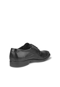 Chaussure habillée pour homme en cuir noir poli avec lacets, talon bas et bout rond, présentée de profil sur un fond blanc.