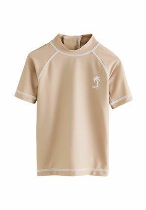 Rash guard beige a maniche corte con colletto alto, cuciture bianche e un piccolo design di palma nell'area sinistra del petto. Materiale elasticizzato morbido.