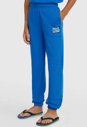 Sinistest pehmest materjalist dressipüksid, millel on elastne vöökoht, kitsenevad mansetid ja väike logoembleem küljetaskul.