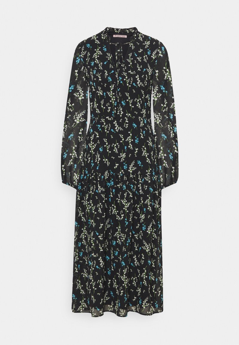 Robe midi noire à manches longues avec un motif floral blanc et bleu, jupe froncée et détail à nouer au col.