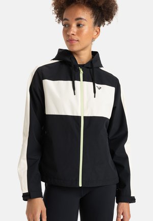 Zwart-witte hooded jack met een voorrits, lange mouwen en een contrast limegroene ritslus. Lichtgewicht stof met een sportief ontwerp.