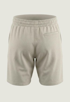 Short beige clair avec taille élastique, poches latérales et une seule poche passepoilée arrière, présenté de dos sur un fond uni.