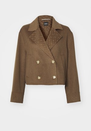 Jachetă croită dintr-un amestec de lână de culoare maro, cu închidere dublă și butoane mari în față, guler cu tăietură și căptușeală interioară cu un model.