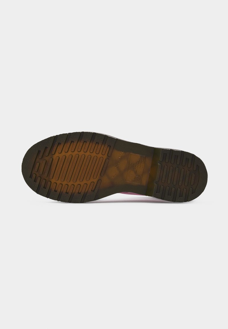 Shoe sole with thick, grooved tread pattern in black and brown, designed for grip and durability, displayed against a plain white background.