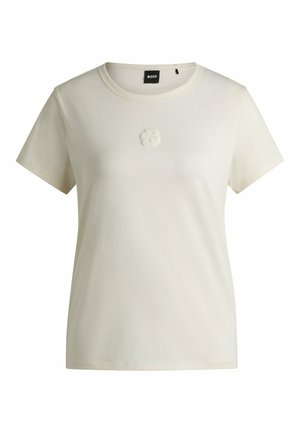 Witte katoenen t-shirt met een ronde hals en korte mouwen. Bevat een zacht textuurlogo op de borst. Rechte zoom.