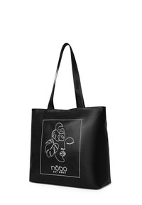 Zwarte leren handtas met twee handvatten, met een witte lijntekening van een gezicht en bladeren, en de merknaam "nōbo" onderaan.