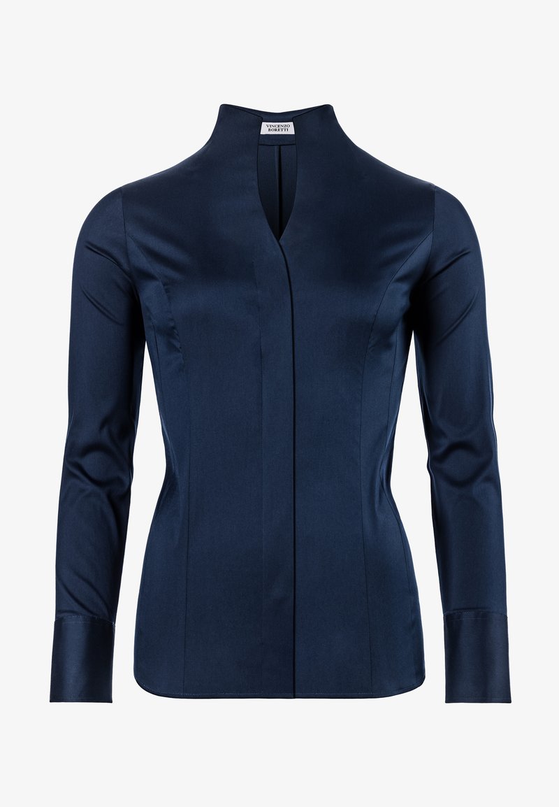 Navy blue long-sleeve shirt with a high collar, featuring a front slit and clean lines. Made from smooth fabric with structured fit.