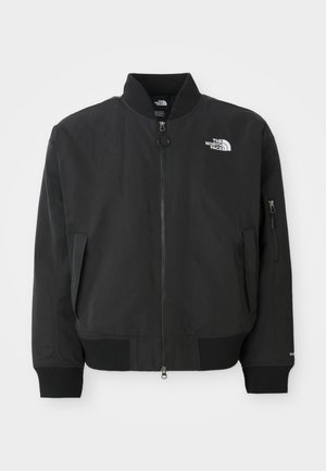 Black bomber jacket made of smooth fabric, featuring a round neckline, ribbed cuffs, and zippered side pockets. The North Face logo is on the chest.
