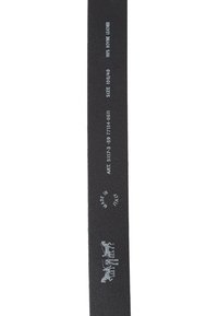 Black leather strap with embossed markings. Features text detailing: "100% bovine leather," size, and "Made in Italy." Smooth texture.