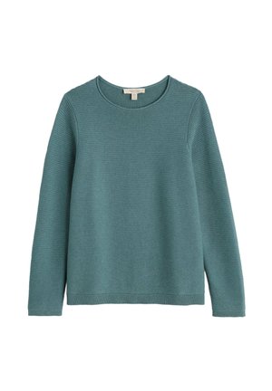 Melsvos megztinis su briaunomis, ilgomis rankovėmis ir apvaliu iškirpimu. Išskirtinis audinys su tekstūra ir tiesi apdailos linija. Nėra matomų raštų.