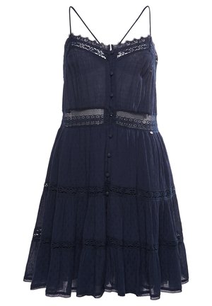 Navy blue sleeveless dress with thin straps, lace trim, front buttons, and tiered skirt with sheer crochet detailing.