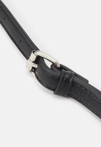 Cintura in pelle nera con texture liscia, dotata di una fibbia in metallo argentato e fori per la regolazione della misura.