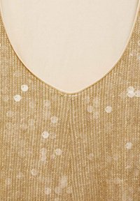 Gold sequined top with a V-neckline. Textured fabric featuring vertical stripes and round sequins scattered across the surface.