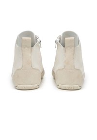 Beige suede ankle boots with a textured finish, featuring a zip closure at the back and a rubber outsole for grip.