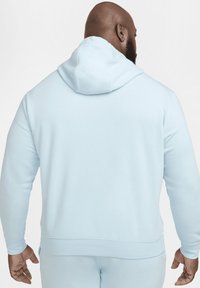 Felpa con cappuccio azzurro chiaro, caratterizzata da una texture morbida e polsini a costine, dotata di una tasca a marsupio nella parte anteriore e una vestibilità comoda.